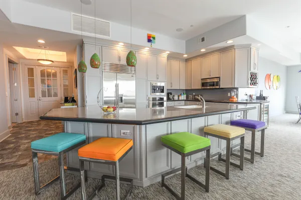 a kitchen with stainless steel appliances kitchen island granite countertop a table and chairs