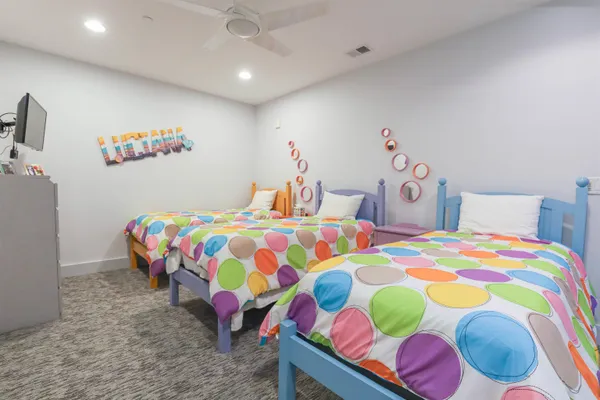 a bedroom that has a bed and a dresser in it