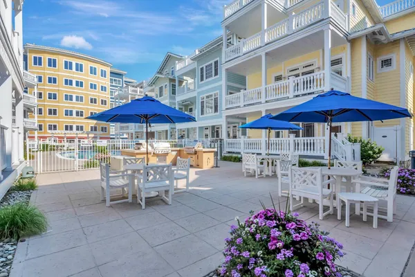 a view of a patio with a table and chairs under an umbrella