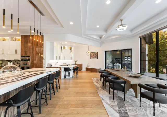 a view of a a dining room with furniture window and wooden floor