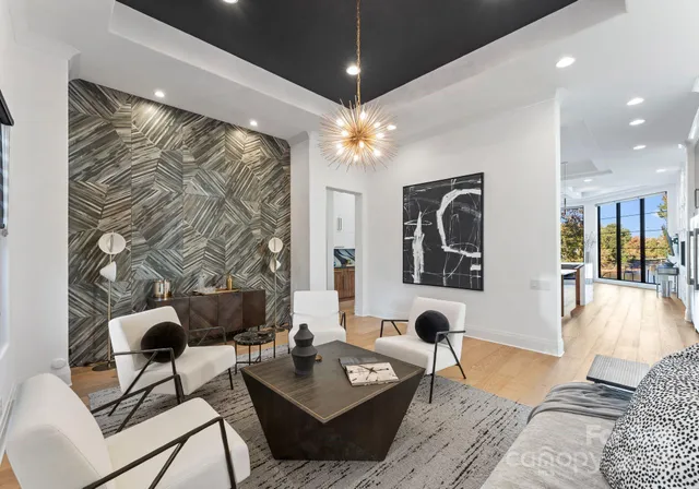 a living room with furniture and a chandelier