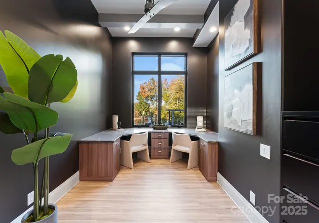 a room with lots of white furniture wooden floor and a large window