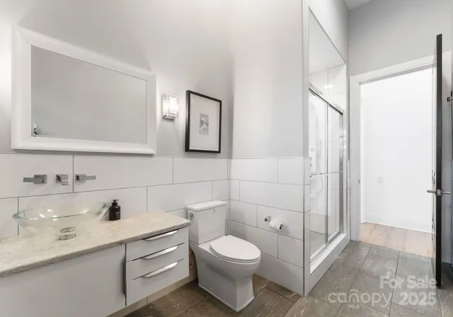 a bathroom with a toilet a sink and mirror