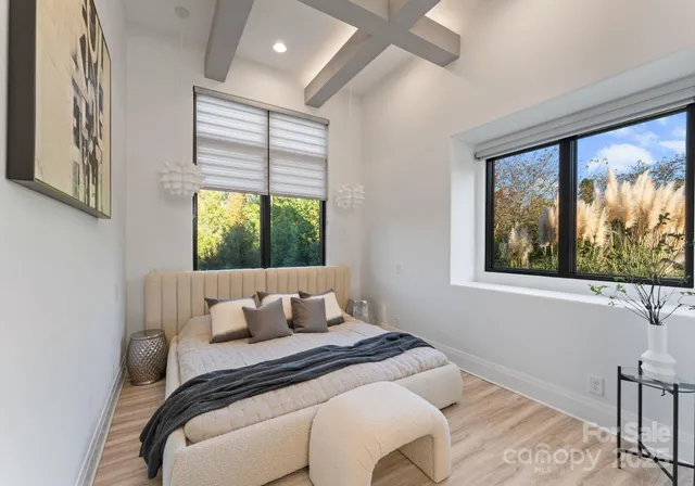 a bedroom with a bed and a large window