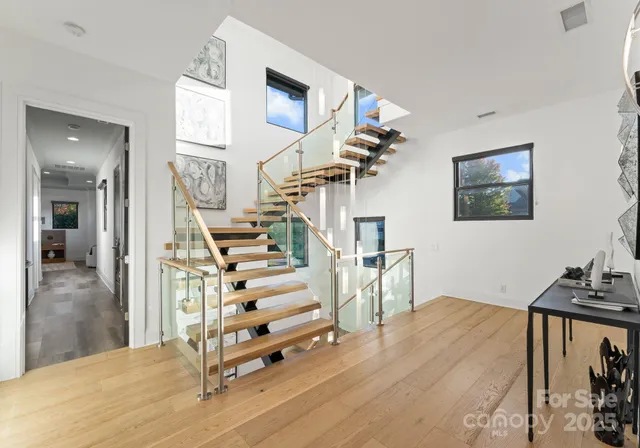 a view of entryway and hall with wooden floor