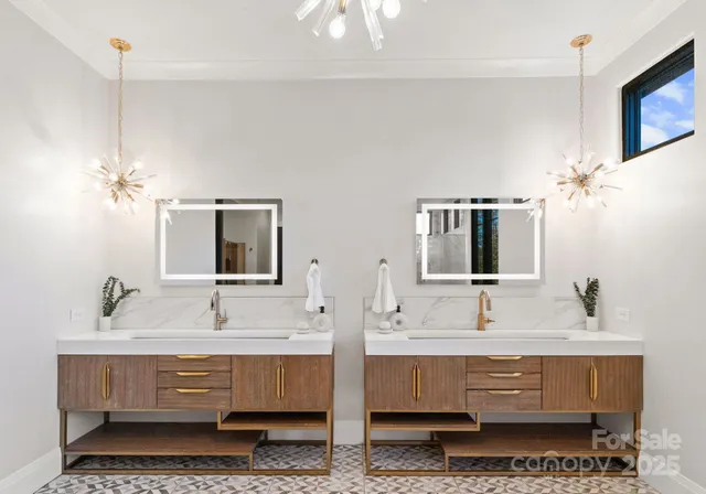 a bathroom with double vanity sinks and a mirror
