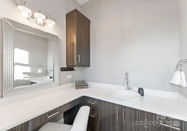 a kitchen with a sink and a mirror