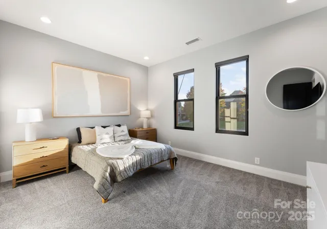 a spacious bedroom with a bed and window