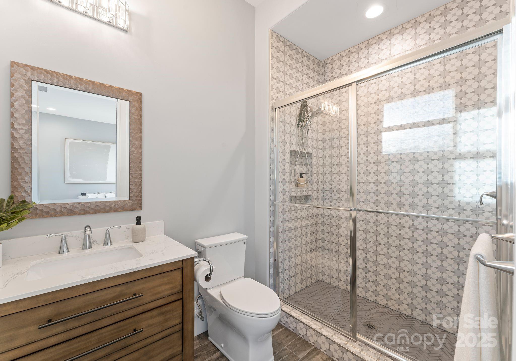 134 Cape Cod Way Mooresville, NC 28117 - Photo 36 of 46 a bathroom with a granite countertop sink a toilet and shower