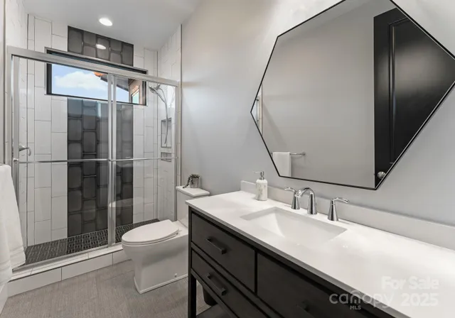 a bathroom with a sink a toilet and shower