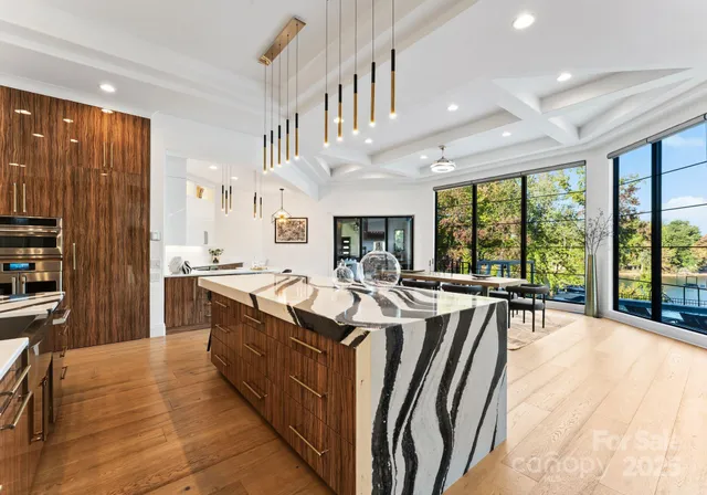 a large kitchen with stainless steel appliances lots of counter space and windows