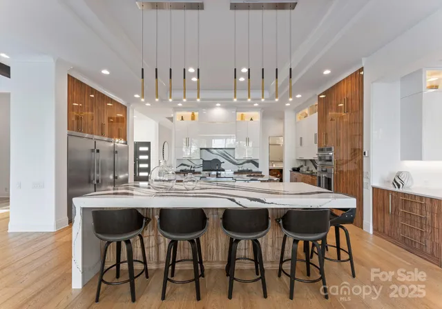 a kitchen with kitchen island granite countertop lots of counter top space and dining table