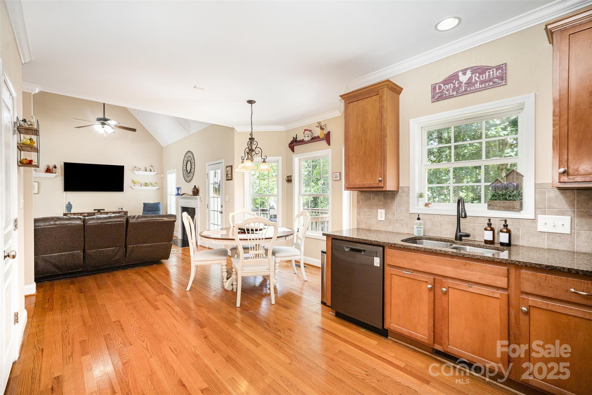 1846 Sam Smith Road Fort Mill, SC 29708 - Photo 10 of 33 a large white kitchen with stainless steel appliances kitchen island granite countertop a sink and a wooden floor