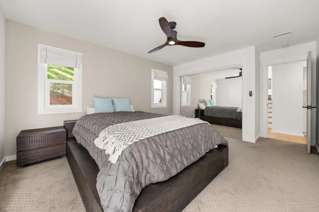 a spacious bedroom with a bed and a chandelier