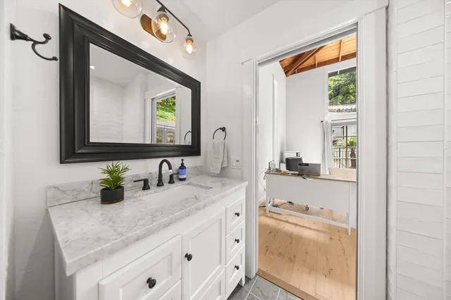 a bathroom with a double vanity sink and a window