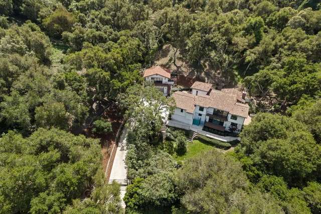 an aerial view of a house with yard swimming pool and outdoor seating