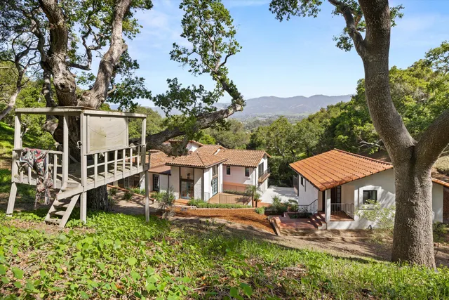 an aerial view of a house with a yard in front of it