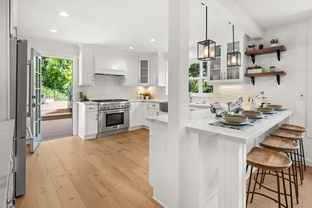 a kitchen with stainless steel appliances granite countertop a stove and a sink