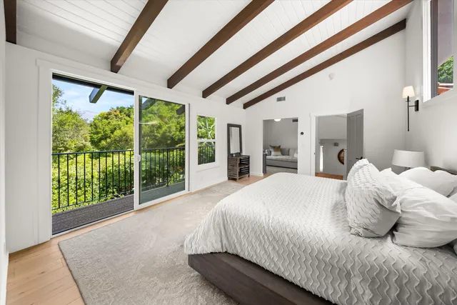 a bedroom with a large bed and a large window