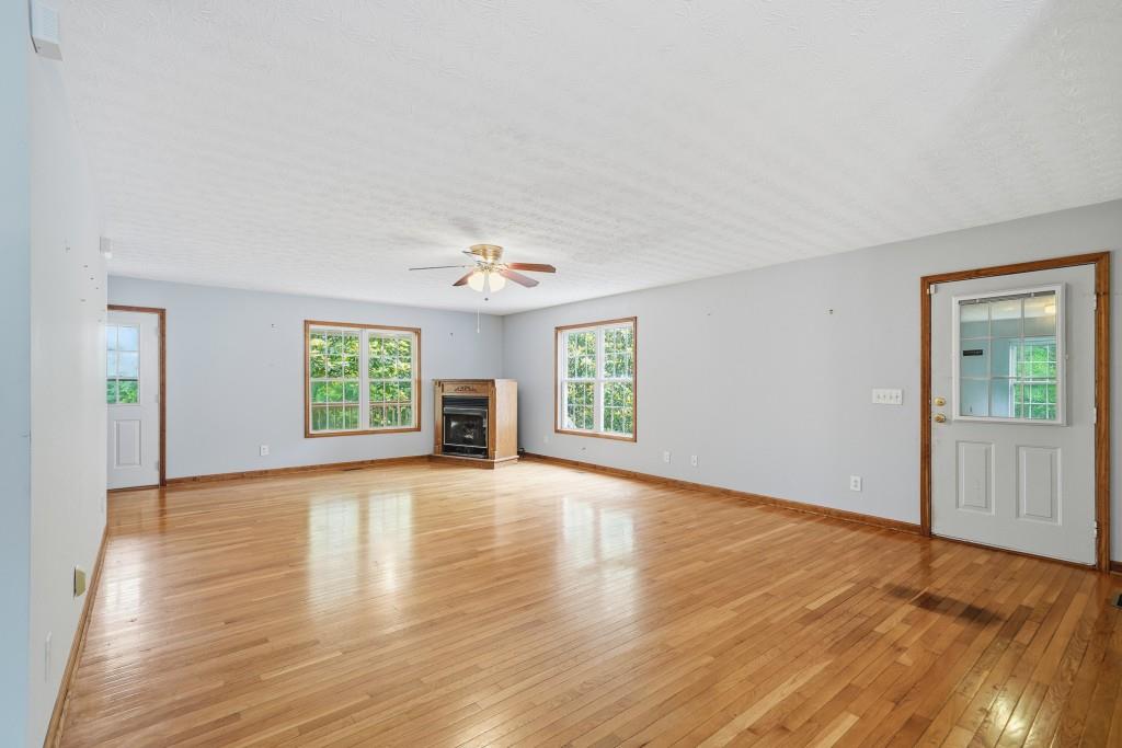 176 Big Oak Tree Road Northwest Adairsville, GA 30103 - Photo 22 of 77 a view of an empty room with a window and wooden floor