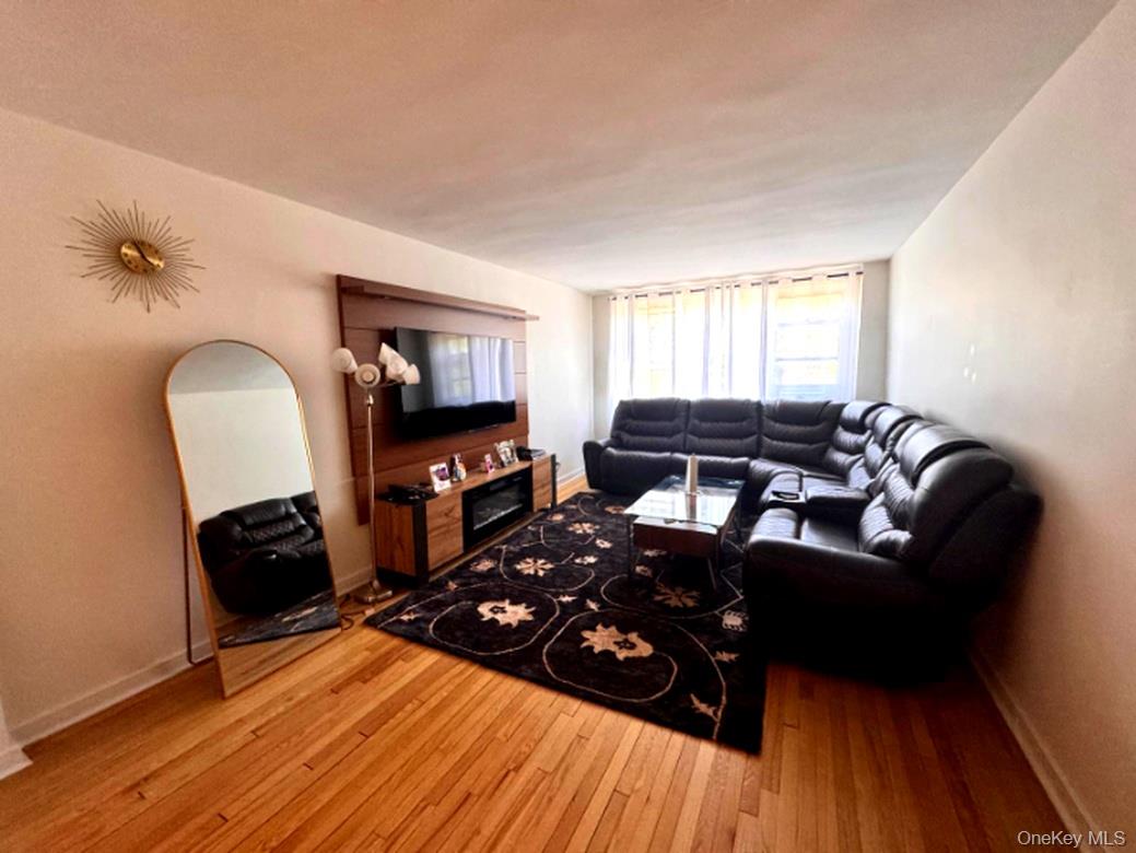4320 Van Cortlandt Park East, Unit 6E Bronx, NY 10470 - Photo 2 of 11 a living room with furniture and a flat screen tv