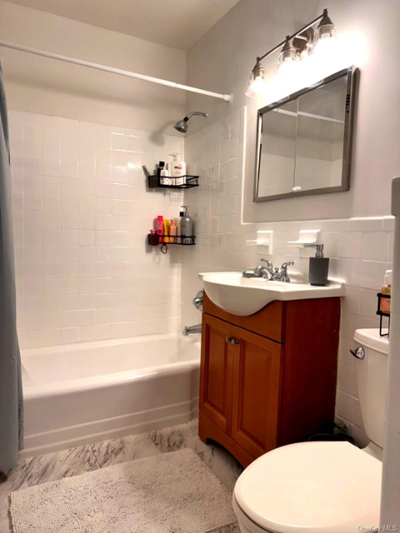 4320 Van Cortlandt Park East, Unit 6E Bronx, NY 10470 - Photo 9 of 11 a bathroom with a sink a toilet and bathtub