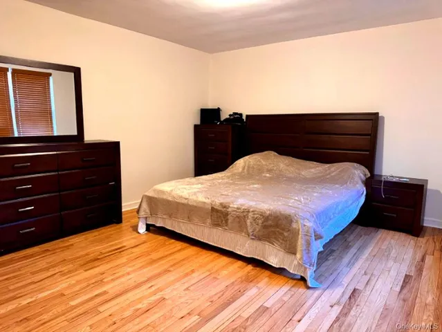 a bedroom with a bed and dresser
