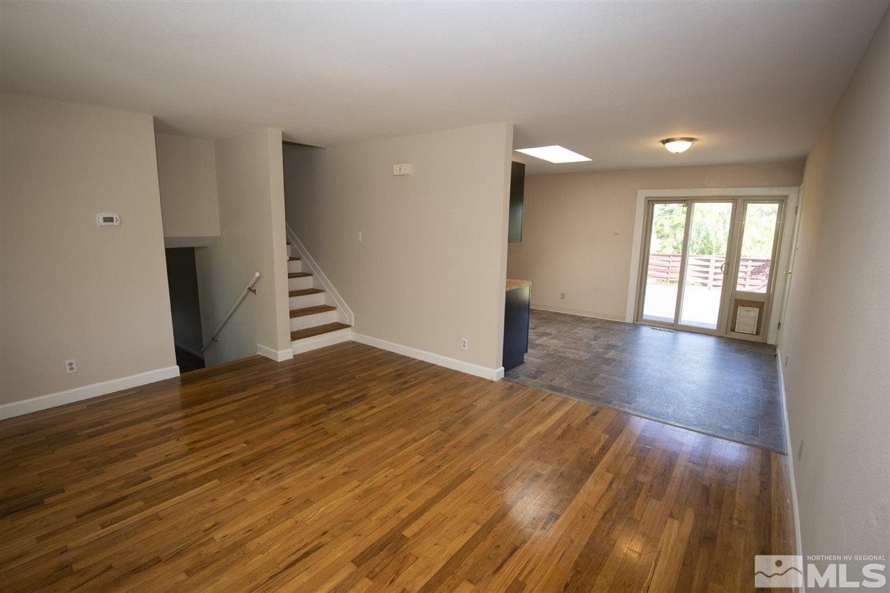 3240 Bryan Street Reno, NV 89503 - Photo 3 of 23 a view of an empty room with wooden floor and stairs