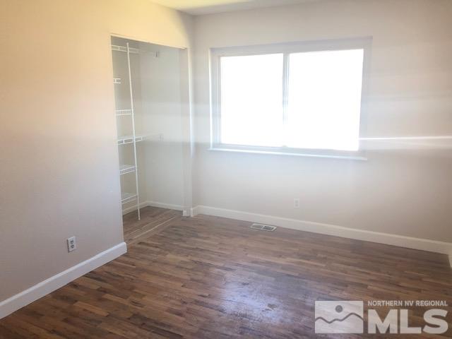 3240 Bryan Street Reno, NV 89503 - Photo 8 of 23 an empty room with wooden floor and windows