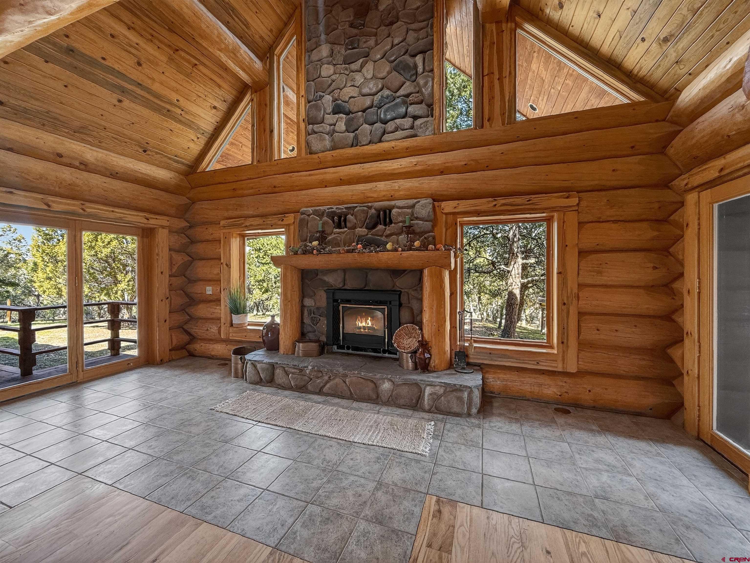 1830 Black Canyon Road Crawford, CO 81415 - Photo 7 of 45 a view of an empty room with a fireplace and a window