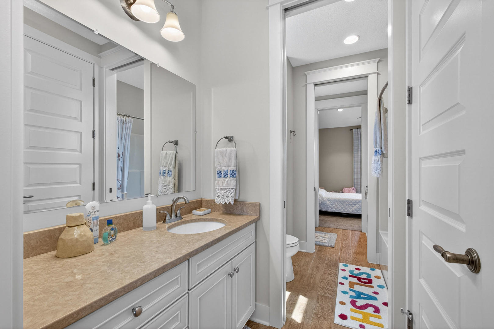 5700 Emily Road Bettendorf, IA 52722 - Photo 24 of 58 a en suite bathroom with a granite countertop sink and a mirror