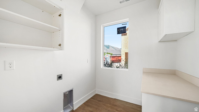 717 South Harrison Drive West Springville, UT 84663 - Photo 8 of 31 Utility room featuring wood-finish flooring, white cabinetry, integrated shelving, a rectangular window, and light-toned countertops