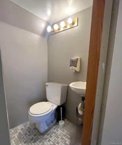 a white toilet sitting next to a small sink