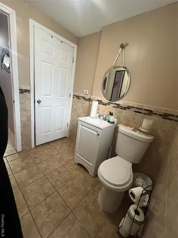 a bathroom with a toilet sink and shower