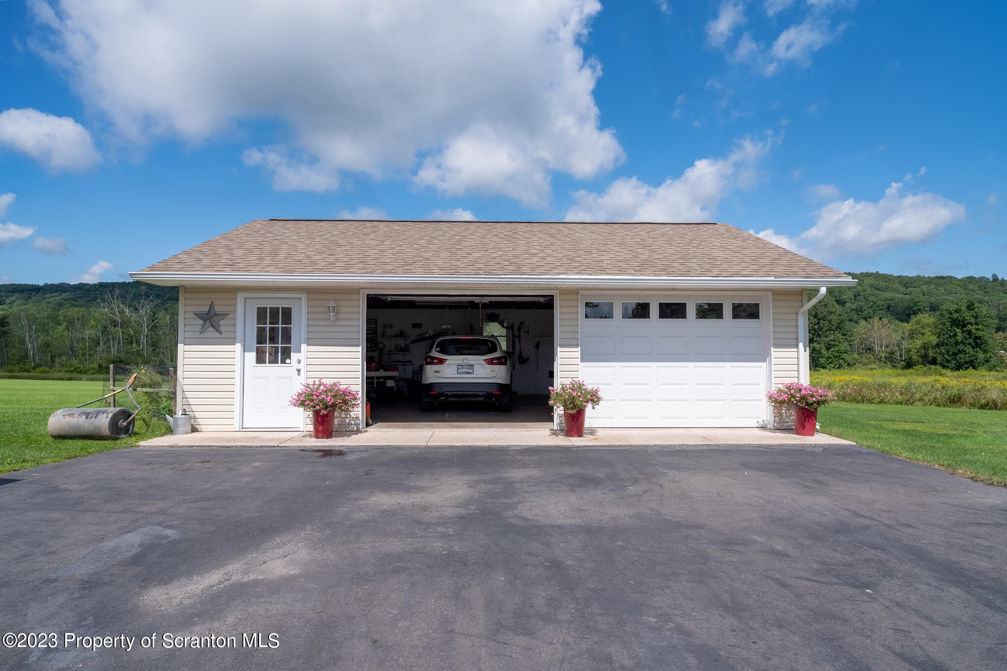 1213 Post Hill Road Falls, PA 18615 - Photo 5 of 21 a front view of a house with a yard and garage