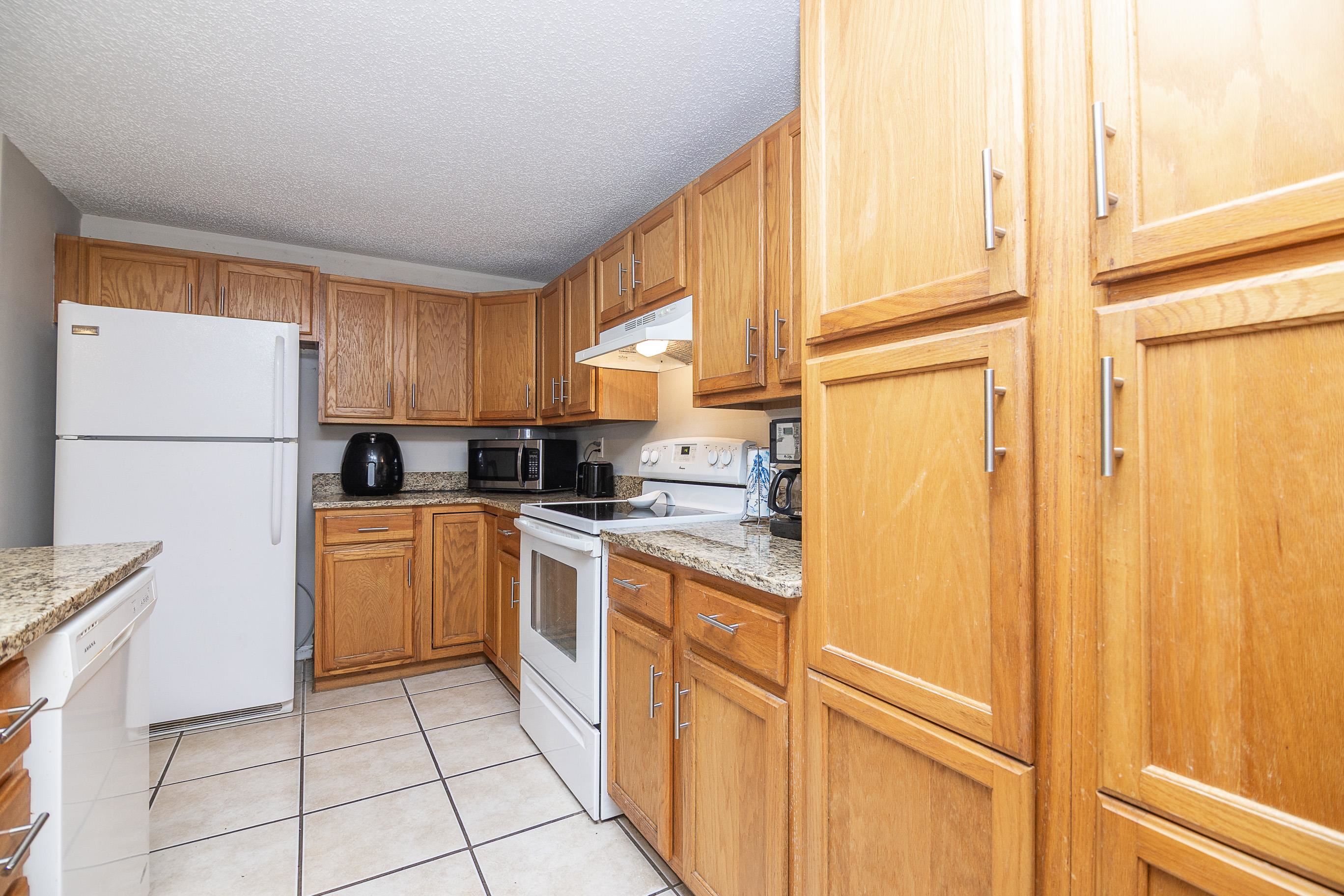 1 Talavera Court St. Augustine, FL 32086 - Photo 12 of 28 a kitchen with stainless steel appliances granite countertop a refrigerator a sink and white cabinets