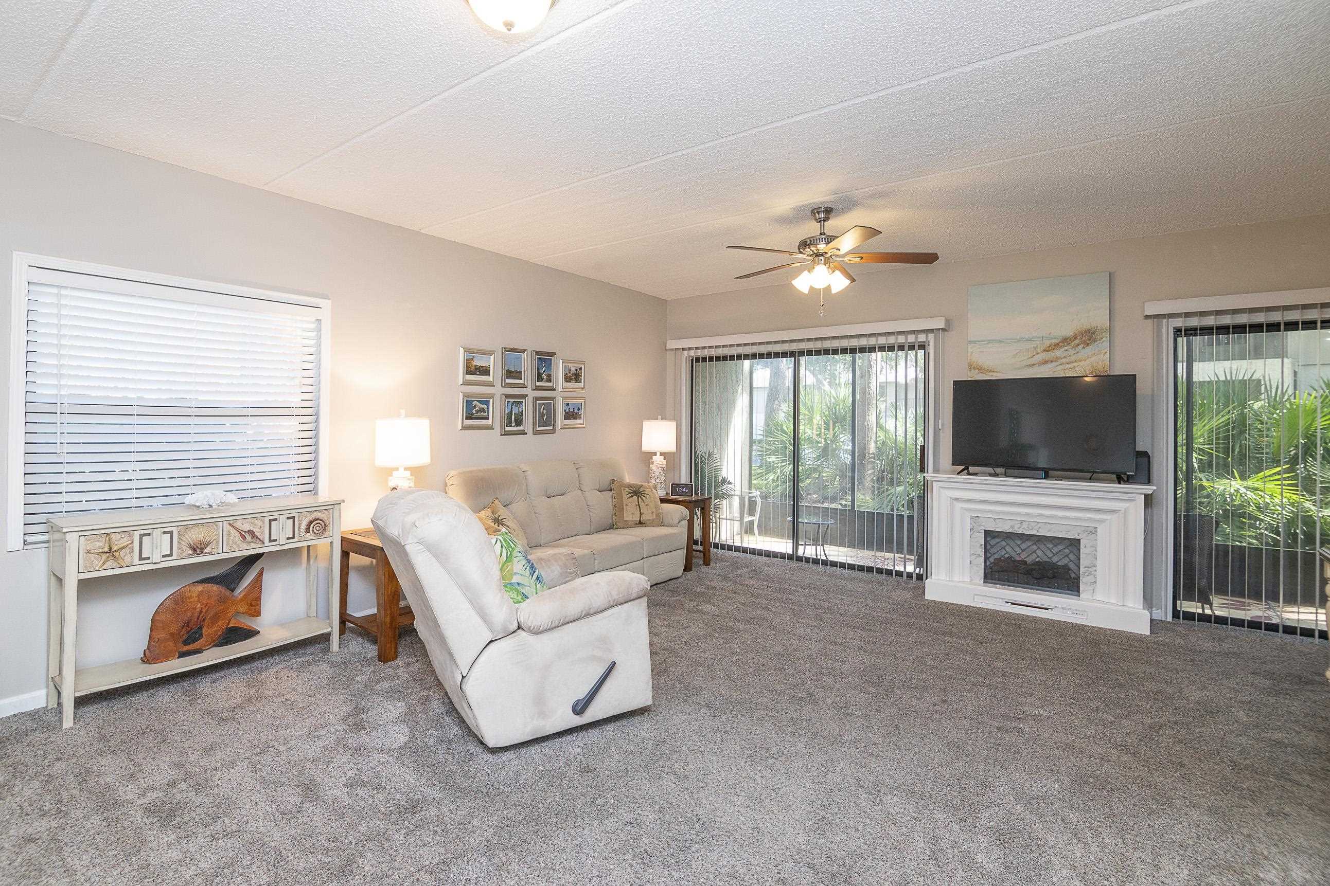 1 Talavera Court St. Augustine, FL 32086 - Photo 6 of 28 a living room with furniture a flat screen tv and a fireplace