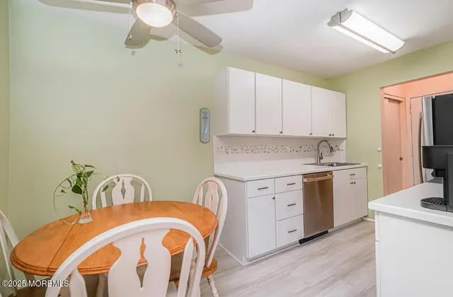a view of a kitchen with a dining table chairs stove and kitchen view