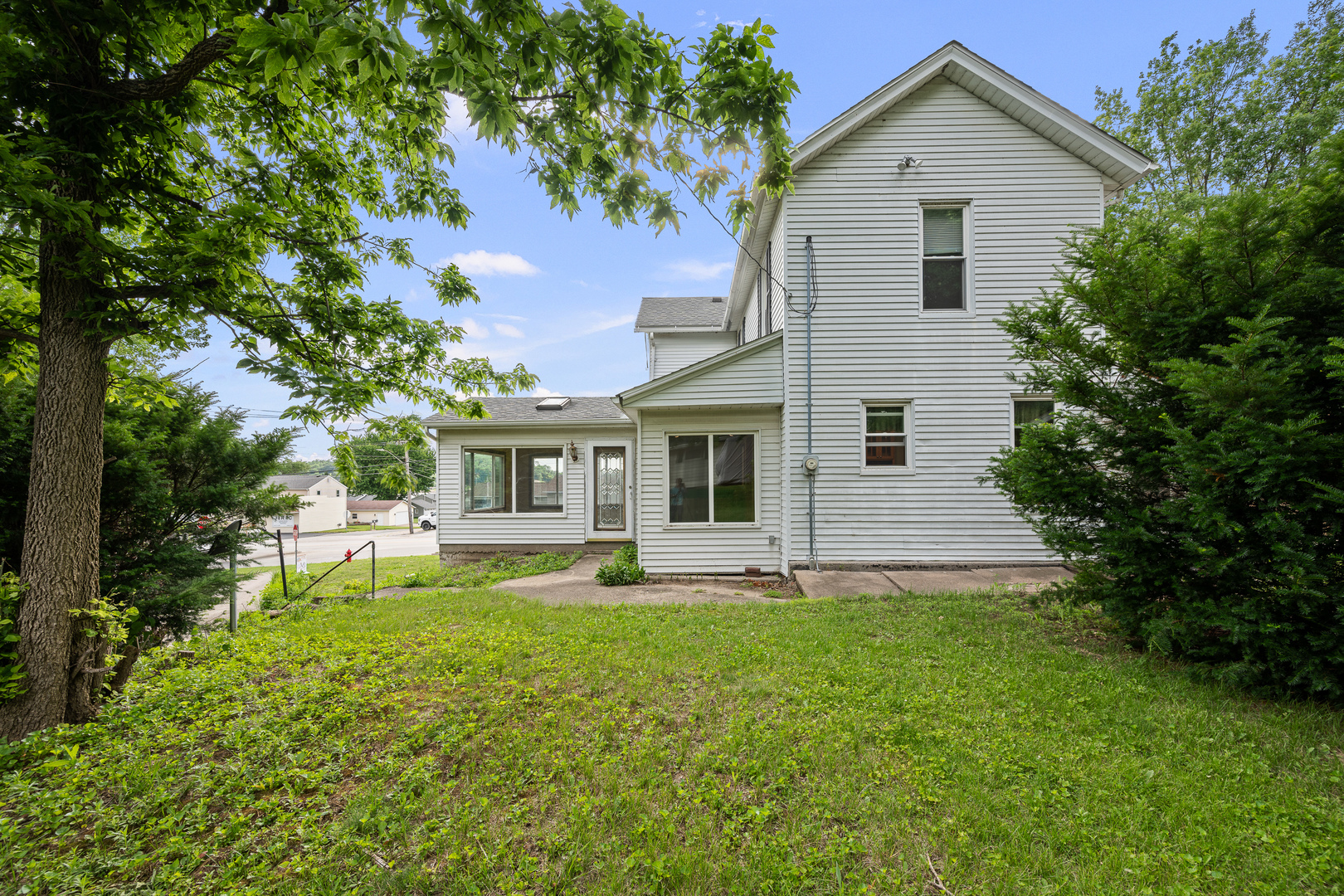 802 North High Street Port Byron, IL 61275 - Photo 7 of 43 a front view of a house with a yard and trees