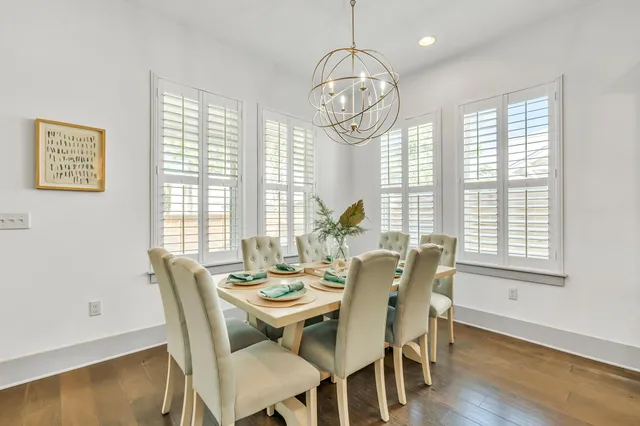 a view of a dining room with furniture wooden floor and chandelier