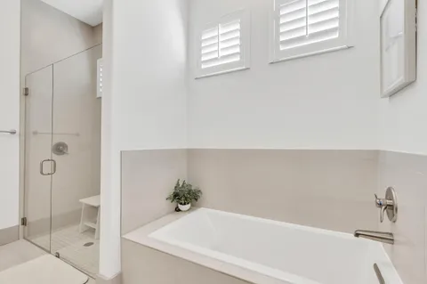 a bathroom with a bathtub and shower