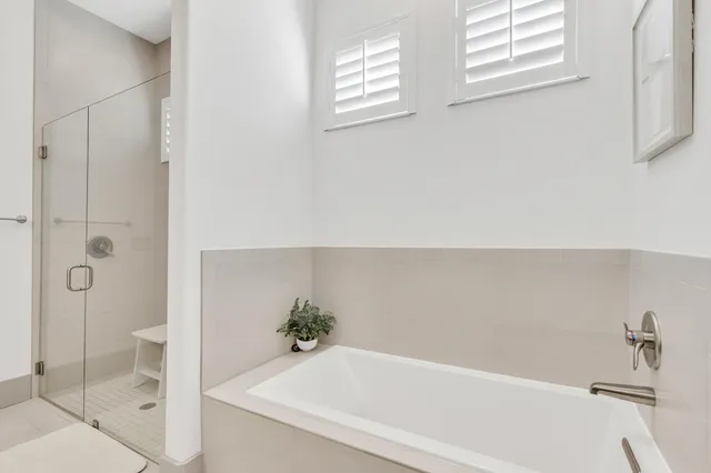a bathroom with a bathtub and shower