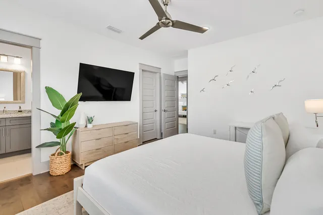 a bedroom with a bed and a flat screen tv