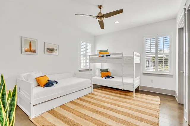 a living room with baby crib furniture and a window