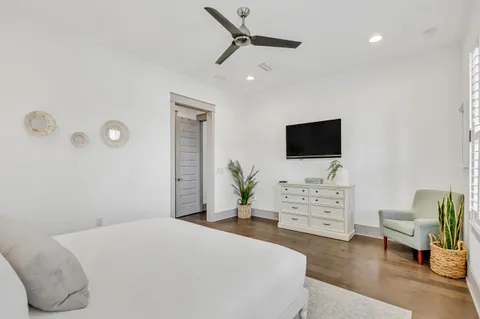 a bedroom with a bed and flat screen tv