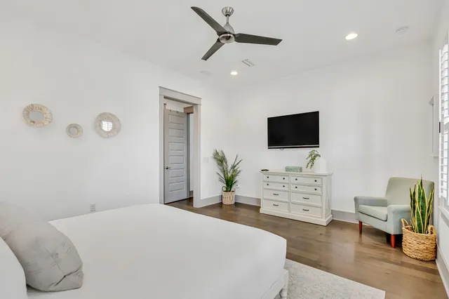 a bedroom with a bed and flat screen tv