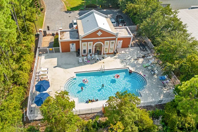 an aerial view of a house with a yard and garden