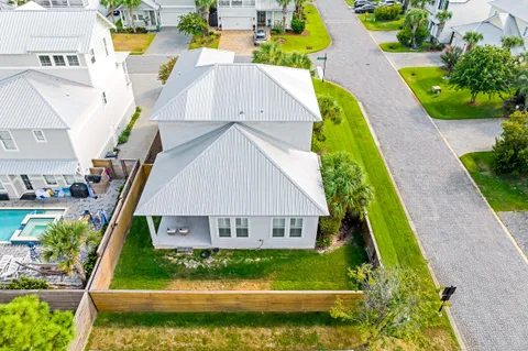 a view of swimming pool with a garden and plants