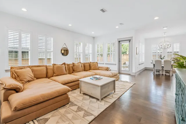a living room with furniture and wooden floor