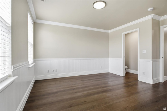 4496 West 11800 South South Jordan, UT 84009 - Photo 22 of 33 Unfurnished room with dark wood-style flooring, a wainscoted wall, crown molding, and a smoke detector